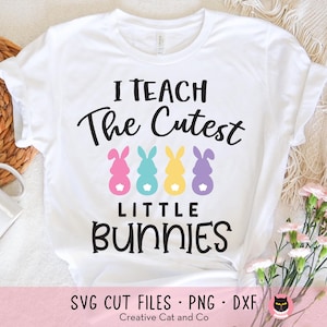 May include: White t-shirt with black text that reads "I teach the cutest little bunnies". Four colourful bunny silhouettes are displayed below the text.