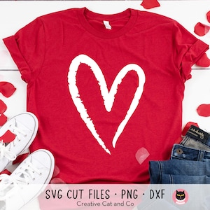 May include: Red t-shirt with a white hand-drawn heart design. SVG cut files, PNG and DXF.