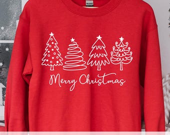Könnte beinhalten: Roter Pullover mit einem weißen Umriss von vier Weihnachtsbäumen und dem Text "Frohe Weihnachten".