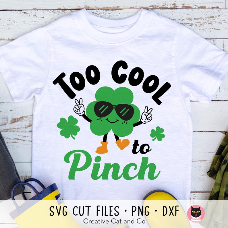 May include: A white t-shirt with a green shamrock wearing sunglasses and the text "Too Cool to Pinch".