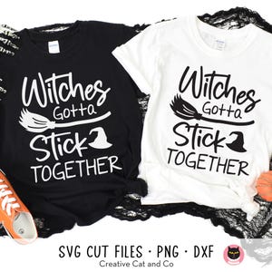 May include: Two black and white t-shirts with a witch's broom and hat graphic. The text on the shirts reads "Witches Gotta Stick Together".