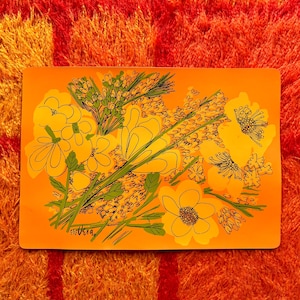 May include: Orange rectangular tray with a floral design. The tray features yellow flowers and green stems with black outlines. The background is orange, and the artist's signature "Vera" is in the bottom left corner.