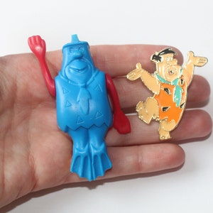 2 Vintage Fred Flintstones Figures, 1970s Kelloggs Flintstone Swimmer Fruity Pebbles and Hanna Barbera Fred Flintstone Enamel Pin
