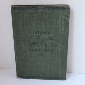 May include: A green book with the title "Arnold's Practical School Sabbath Lesson Commentary 1901" printed on the front cover.