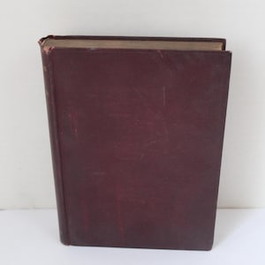 May include: A burgundy hardback book with a gold spine.