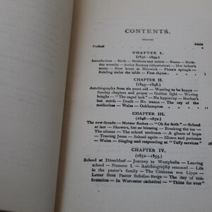 May include: A black and white book with the title "CONTENTS" printed on the cover. The book is open to a page with a table of contents listing chapters and their corresponding page numbers. The chapters are titled "Introduction", "Autobiography from six years old", "The new decade", and "School at D&uuml;sseldorf".