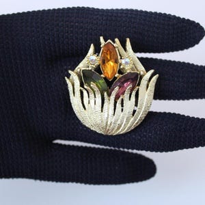 May include: A set of three ceramic mugs with a speckled, matte finish. The mugs are in shades of cream, light gray, and dark gray. Each mug has a simple, minimalist design and a rounded handle.