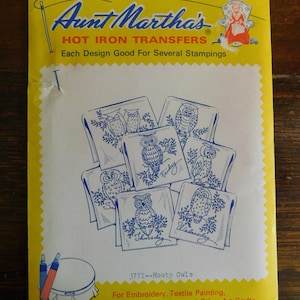 May include: A yellow Aunt Martha's Hot Iron Transfers packet featuring blue line art of owls on square backgrounds. The text reads Aunt Martha's HOT IRON TRANSFERS, Each Design Good For Several Stampings, 3771--Hooty Owls, and For Embroidery, Textile Painting, Needlepoint Canvas and Other Art Crafts.