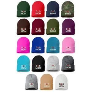 May include: A collection of beanies in various colors, each embroidered with "DOG MOM" and a paw print. Colors include green, red, navy, camouflage, brown, burgundy, olive, purple, pink, blue, teal, and gray.