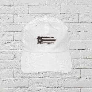 May include: White distressed baseball cap with a black and white Puerto Rican flag patch.