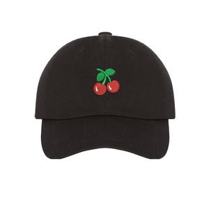 May include: A black baseball cap with a red cherry embroidered on the front.