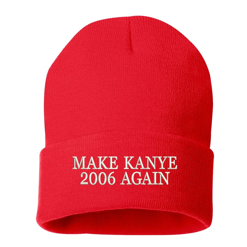 May include: Red knit beanie with white embroidered text that reads "MAKE KANYE 2006 AGAIN".