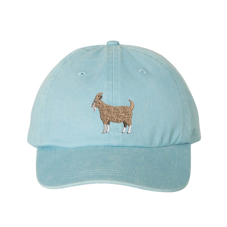 May include: A light blue baseball cap with an embroidered brown goat on the front.