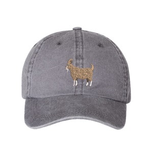 May include: A gray cotton baseball cap with an embroidered brown goat design.