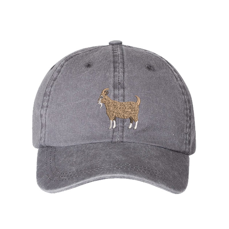 May include: A gray cotton baseball cap with an embroidered brown goat design.