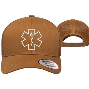 May include: A brown trucker hat with a white embroidered medical symbol, the Star of Life, with a snake and staff. The hat has a mesh back and a brown adjustable strap.
