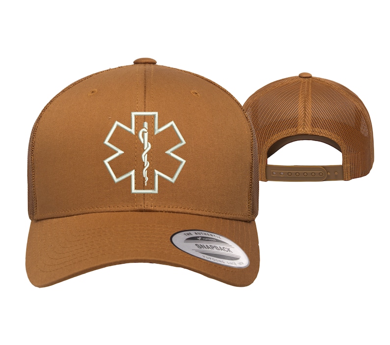 May include: A brown trucker hat with a white embroidered medical symbol, the Star of Life, with a snake and staff. The hat has a mesh back and a brown adjustable strap.