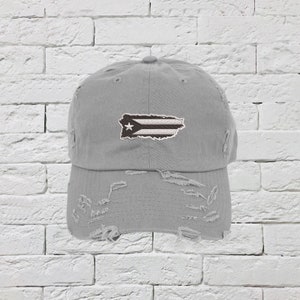 May include: A gray distressed baseball cap with a white and black Puerto Rican flag embroidered on the front.