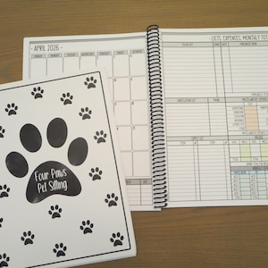 May include: A spiral-bound pet sitting planner with a white cover featuring black paw prints and the text Four Paws Pet Sitting. The open pages display an April 2026 calendar grid and a section for lists, expenses, and monthly totals with colored boxes.