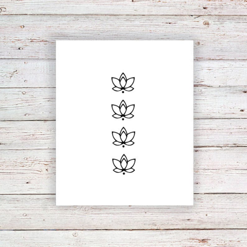 May include: A white sheet of paper with four black lotus flower designs in a vertical row.