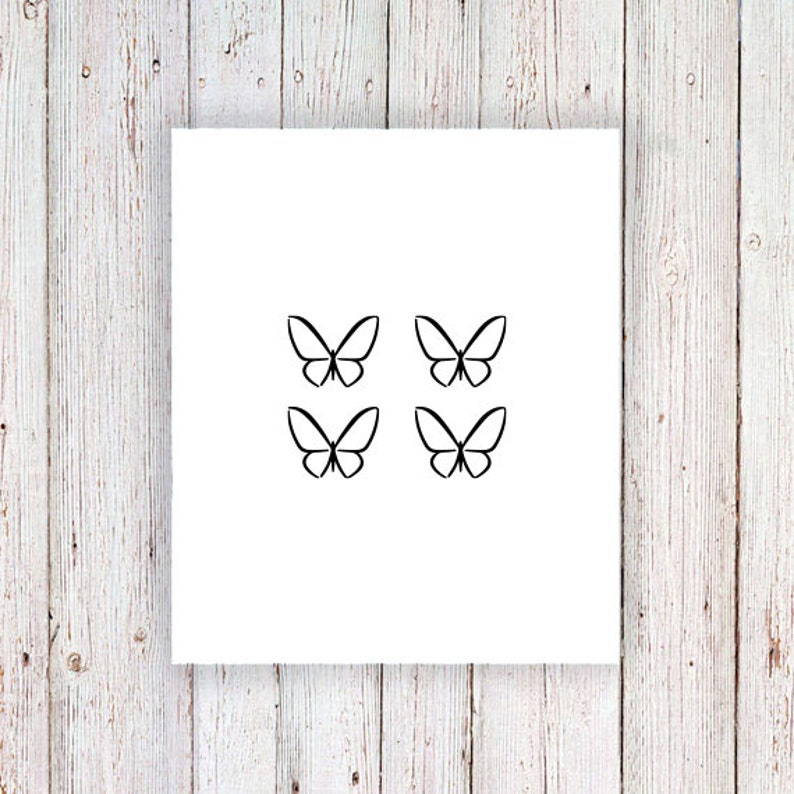 a white card with three black butterflies on it