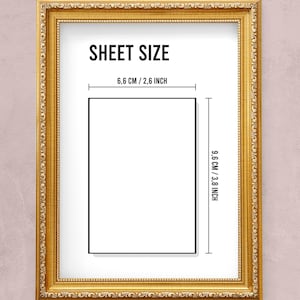 May include: A gold-colored picture frame with a white mat and a white sheet of paper inside. The paper has the text "SHEET SIZE" and the dimensions "6.6 CM / 2.6 INCH" and "9.6 CM / 3.8 INCH" printed on it.