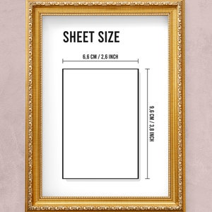May include: A gold-coloured frame with a white mount and black text that reads "SHEET SIZE" and "6.6 CM / 2.6 INCH" and "9.6 CM / 3.8 INCH". The frame is on a light pink background.