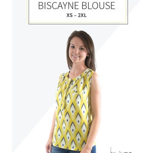 May include: A woman wearing a yellow and blue sleeveless blouse with a geometric pattern. The blouse has a tie at the neckline and a pocket on the left side. The text "Biscayne Blouse XS - 2XL" is above the woman's head. The text "hey june PATTERNS" is below the woman's feet.