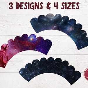 May include: Three printable cupcake wrapper designs featuring a galaxy theme. The designs include a blue and black galaxy, a pink and purple galaxy, and a blue and black galaxy. The text "3 DESIGNS & 4 SIZES" is at the top of the image.