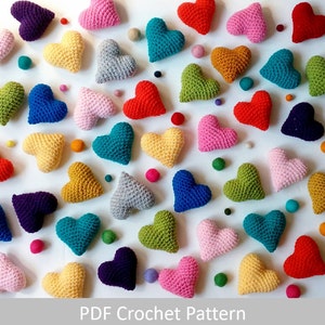 May include: A collection of crocheted hearts in various colors, including red, pink, blue, green, yellow, and purple. The hearts are arranged in a random pattern on a white background.  PDF Crochet Pattern