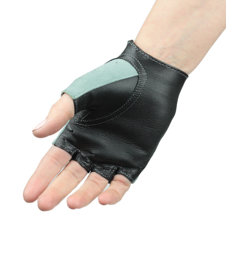 May include: Black leather fingerless gloves with a light green suede panel on the back of the hand.