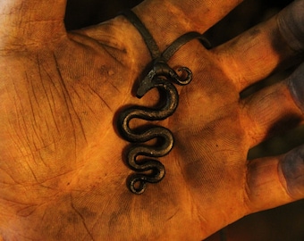 A hand forged Midgård/World serpent pendant . Comes supplied with a high quality elk leather thread.