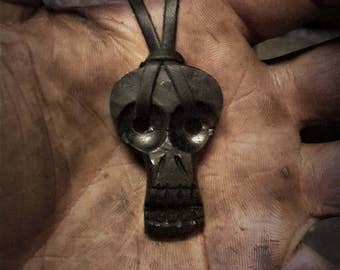 A hand forged Skull pendant . Comes supplied with a high quality elk leather thread.