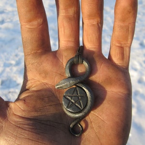 A hand forged serpent pendant with a pentagram in the middle. Comes supplied with a high quality elk leather thread.