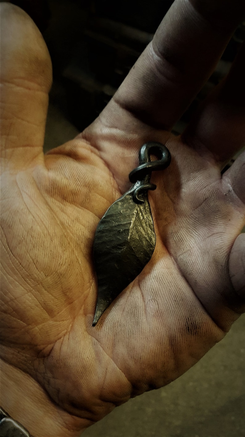 Comes supplied with a high quality elk leather thread. A hand forged Leaf pendant