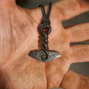 A hand forged Yggdrassil Mjölnir. Comes supplied with a high quality elk leather thread and the price includes postage fees.