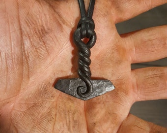 A hand forged Yggdrassil Mjölnir. Comes supplied with a high quality elk leather thread and the price includes postage fees.