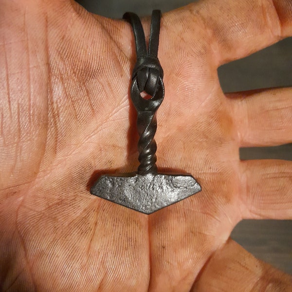 A hand forged Thors hammer Mjölnir with a twisted handle. Comes with a high quality elk leather thread. Price includes postage fees.