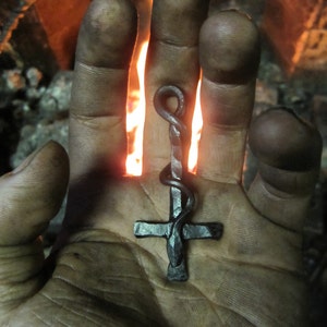 A hand forged inverted Cross & serpent pendant . Comes supplied with a high quality elk leather thread.