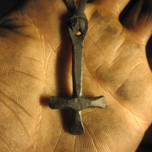 A hand forged inverted Cross pendant . Comes supplied with a high quality elk leather thread.