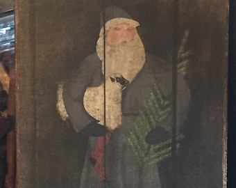 May include: A vintage-style painting of Santa Claus holding a small white bird and a green tree branch. The painting is on a dark brown wooden background.
