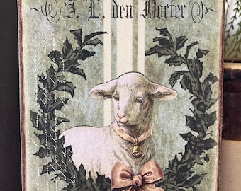 May include: A vintage-style sign with a green background and a white lamb wearing a pink bow and a bell. The sign reads "Hôtel de Hollande Chez J. L. den Dorter N° 2. Allolnir del m".