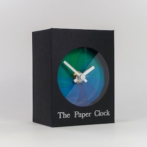 Black Paper Clock modern design gift item with accurate quartz movement, and blue/green colored face.