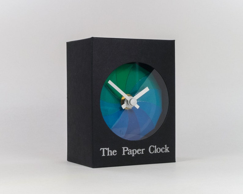 Black Paper Clock modern design gift item with accurate quartz movement, and blue/green colored face. image 1