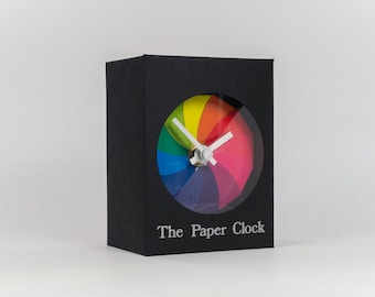 Zwarte papieren klok modern design cadeau-item met nauwkeurige quartz uurwerk, en regenboog gekleurde gezicht.