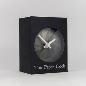 Black Paper Clock modern design gift item with accurate quartz movement, and shades of gray colored face. image 1