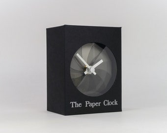 Black Paper Clock modern design gift item with accurate quartz movement, and shades of gray colored face.