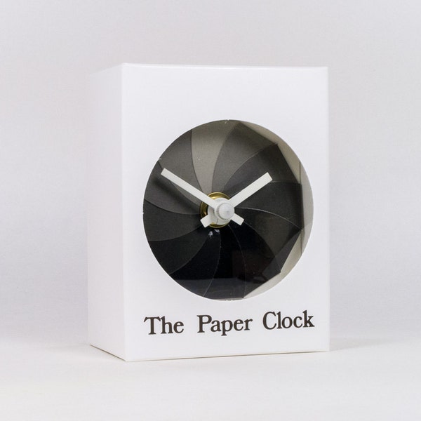 White Paper Clock modern design gift item with accurate quartz movement, and shades of gray colored face.