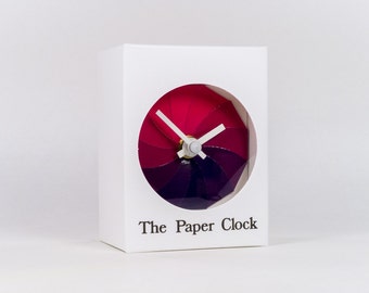 White Paper Clock modern design gift item with accurate quartz movement, and pink/purple colored face.