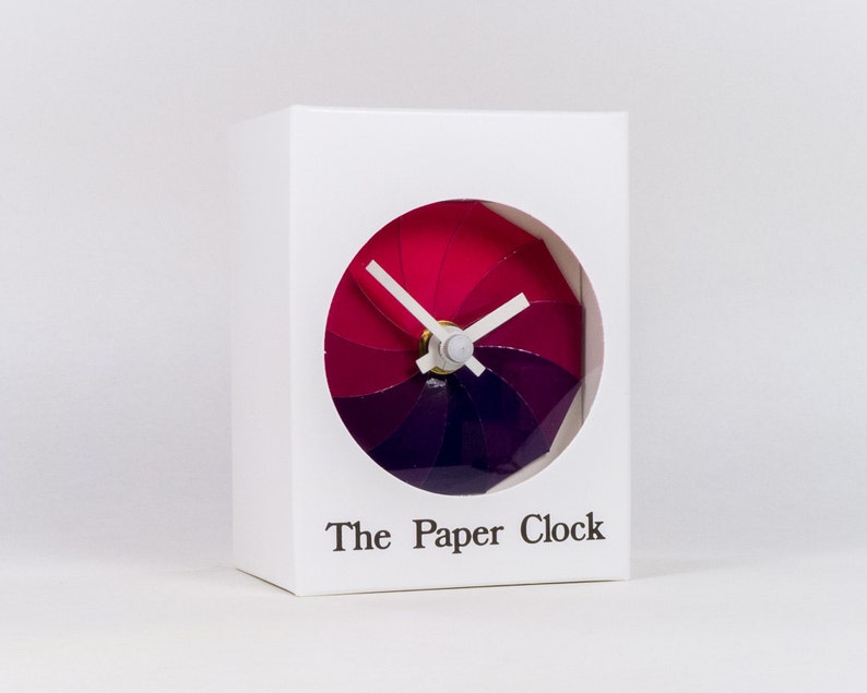 White Paper Clock modern design gift item with accurate quartz movement, and pink/purple colored face. image 1